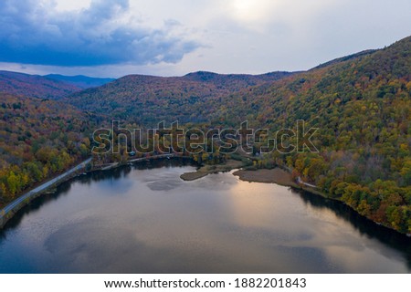 Aerial view of Amherst Lake in fall foliage in Plymouth, Vermont.