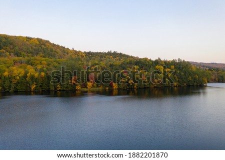 Aerial view of Amherst Lake in fall foliage in Plymouth, Vermont.