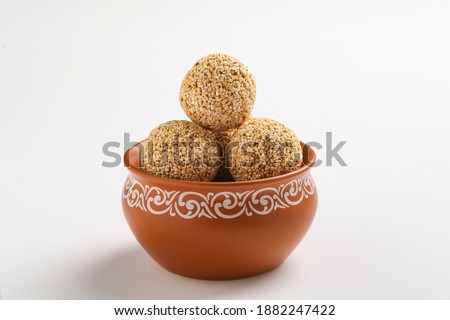 Indian sweet for traditional festival makar sankranti :Rajgira laddu made from Amaranth seed in Bowl on white background Royalty-Free Stock Photo #1882247422