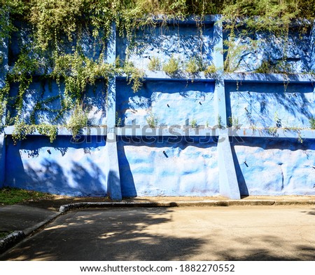 Heavy duty block retaining wall in bright blue color. 