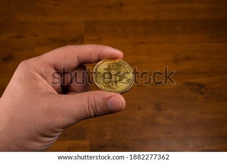 bitcoin coin in hand, cryptocurrency btc close up.