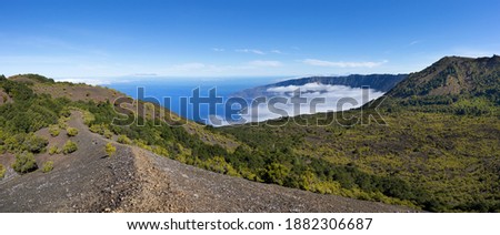 El Hierro - hiking trail on the crater rim of the Tanganasoga volcano with view of the El Golfo Valley covered with clouds