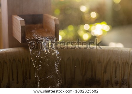 Onsen, Water streaming into wooden bathtub. Relax BGM image. Royalty-Free Stock Photo #1882323682