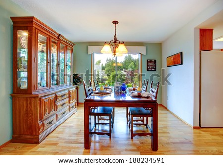 Open dining area with served table and cabinet.