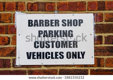 Barber shop sign for customer parking only