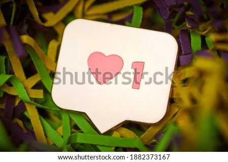 Like symbol. Like sign button, symbol with heart and one digit. Social media network marketing. Multicolored tinsel background.