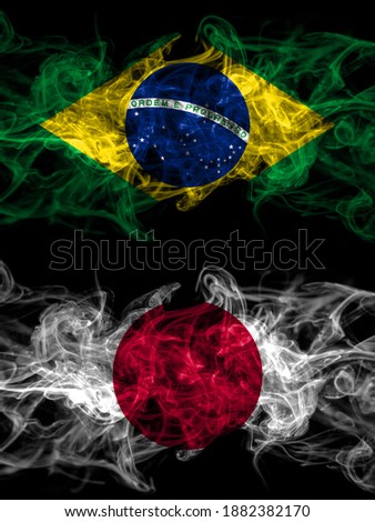Brazil, Brazilian vs Japan, Japanese smoky mystic flags placed side by side. Thick colored silky abstract smoke flags.