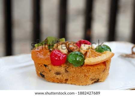 The fruit rum cake on white dish.