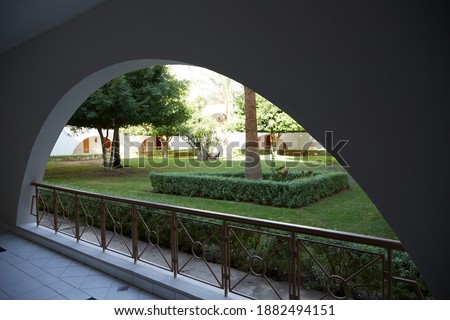 arch in the wall and garden view