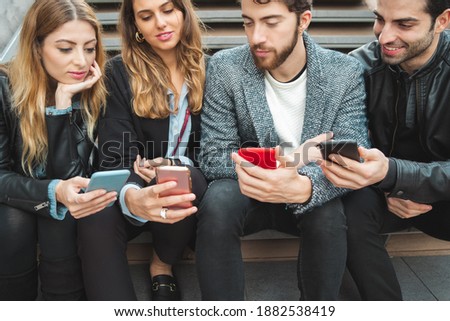 Young people using social media network applications on their smartphone mobile phones. Royalty-Free Stock Photo #1882538419