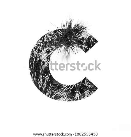 Black letter C of monochrome tinsel and paper cut isolated on white. Festive English alphabet for minimalistic design