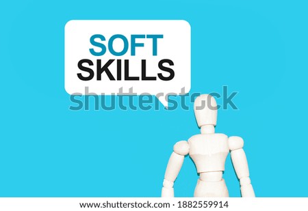 The wooden man and white cloud with text Soft Skills. The content of the lettering has implications for business concept and marketing.