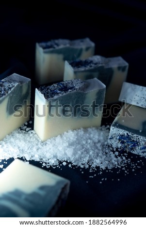 Fresh made bars of handmade soap lying on the dark cloth