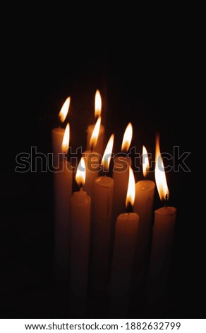 candles glowing in dark region 