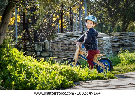 Portrait of a smiling boy riding bicycle at park