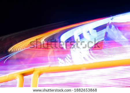 View of illuminated roller coaster at amusement park