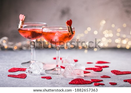 Festive pink cocktail with champagne or prosecco  for St. Valentine's day. Couple of glasses