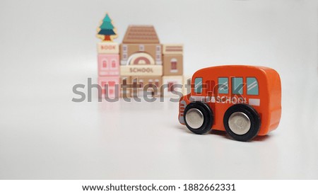 
Colorful wooden children's toys shaped like cars, trees, police stations, schools and fire stations on a gray background