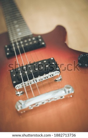Electronic guitar in sunburst optic lying on the wooden floor