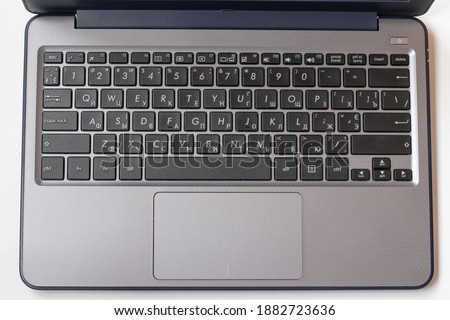 Laptop keyboard black on gray background. Close-up of laptop keyboard