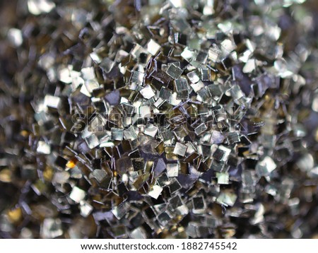 A macro detail of shiny glitter on a Christmas decoration.