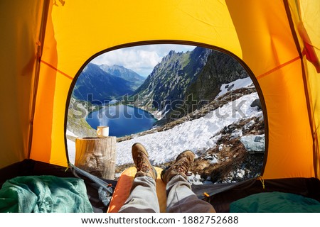 Spectacular view of nature from open tent entrance. The beauty of romantic trekking and camping. 