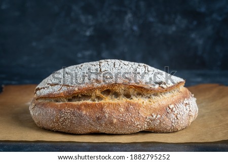 Natural loaf of yeast-free sourdough bread on table, close up