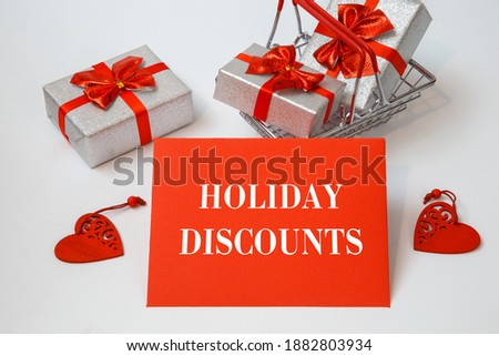 Shopping cart with holiday purchases and text HOLIDAY DISCOUNTS on a red card, white background.
