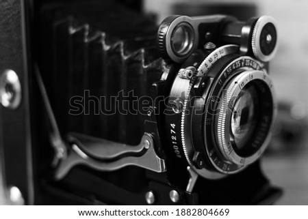 The lens of an old film rangefinder camera