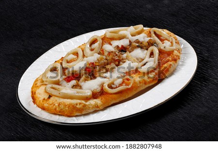 pizza squid seafood oval baked food arab black background 