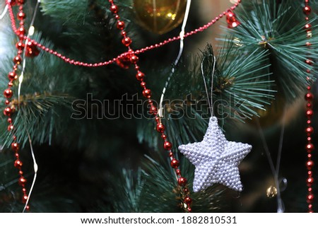 Christmas toys hang on the green tree