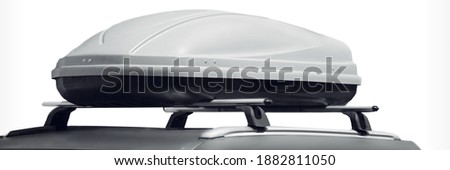 Car With Trunk Box Isolated On White Background. SUV Car Roof With Luggage Box On Rooftop On The Rack System Isolated. Closeup Of Roadster Car Roof Box And Rack System On Rooftop. Royalty-Free Stock Photo #1882811050