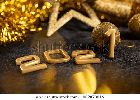 Golden 2021 number on a black background. Happy New Year celebrate banner.