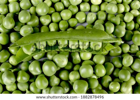 Fresh green peas with glass bowl and pod isolated on white background