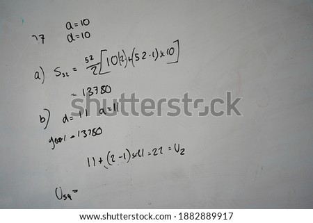 Maths equations on a classroom whiteboard  