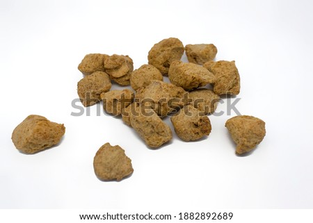 Collection of soya chunks with shallow depth of field isolated on white.