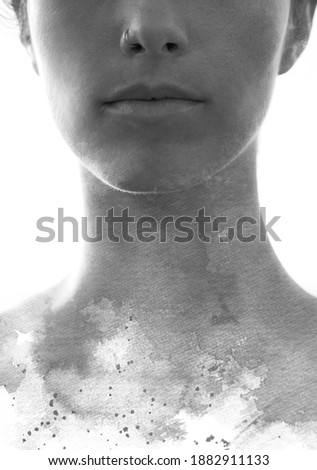A portrait of a woman with an overlay of paint splashes along the collarbones 