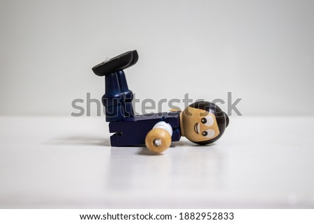 Wooden dummy on a white background. Wooden dummy exhibits exercise moves. The importance of exercise for a healthy life. Exercise movements concept.
