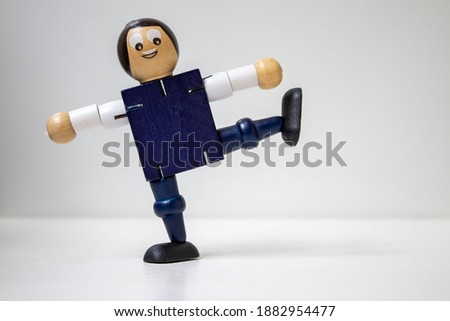 Wooden puppet figure on a white background. Wooden puppet display dance figures. Dance figures concept