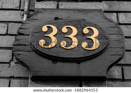 Gold House and Building Address Numbers 333 on Old Wooden Sign in black and white.