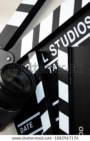 Close-up clappers and camera objectifs cinema education concept, scriptwriting concept. backlight, top view