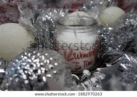 Little candle in silver tinsel