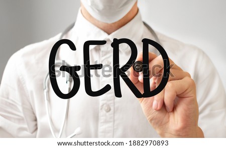 Doctor writing word GERD with marker, Medical concept Royalty-Free Stock Photo #1882970893