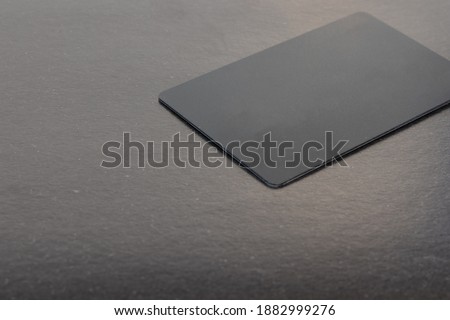 simple gray background poster concept advertising picture with credit card on soft focus textured surface with empty copy space for your text here  