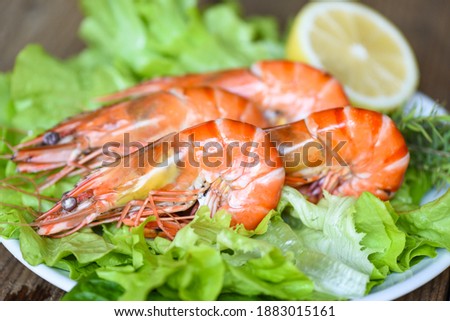 Boiled shrimps prawns on plate seafood restaurant fresh shrimp with ingredients salad vegetables