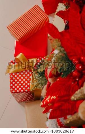 Many gift boxes with red and gold paper on the floor.