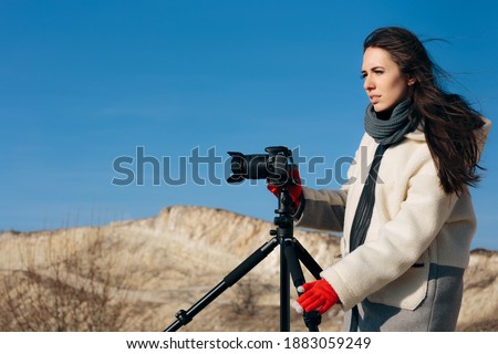 Female Nature Photographer Taking Pictures in Nature. Artist shooting landscapes and wildlife while traveling
