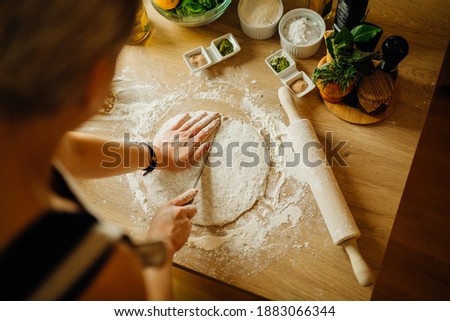 House wife making quick easy homemade crunchy crust dough from scratch by hand. Gluten free.Gluten intolerance.Low carb substitute.Ingredients for pie baking.Bread making.Cooking at home. Royalty-Free Stock Photo #1883066344