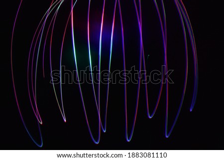 beautiful abstract theme of multi colored red green blue spectrum light painting evil dark night streaks ray blowing art glowing energy neon