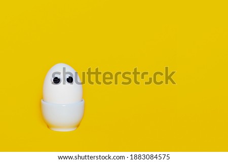 Creative easter banner concept. Happy easter. White chicken egg with eyes. Copy space.